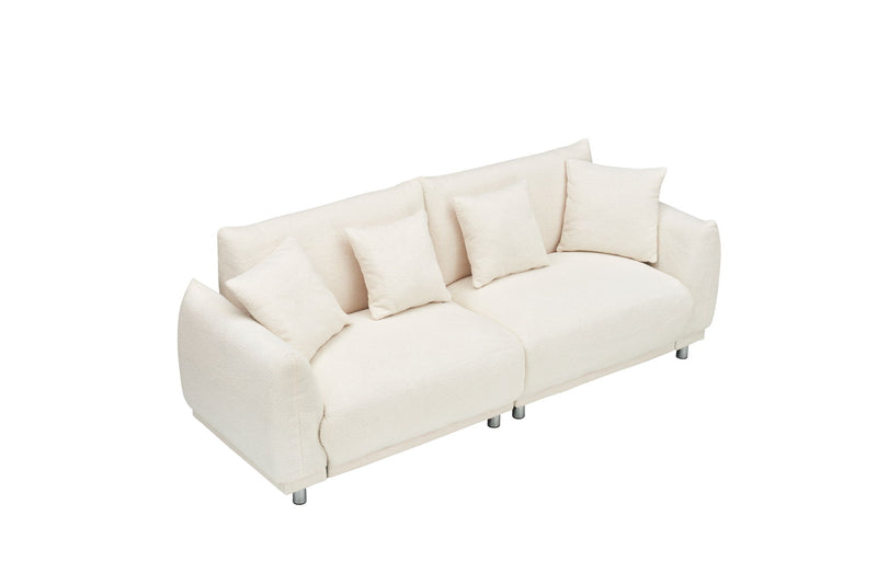 Teddy Wool Beige Sofa With Four Throw Pillows And Hardware Feet Can Sit Comfortably In An Apartment Bedroom Without Taking Up Space